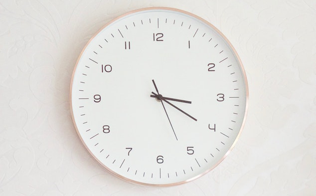 modern clock on a wall symbolizing average handle time in the call center