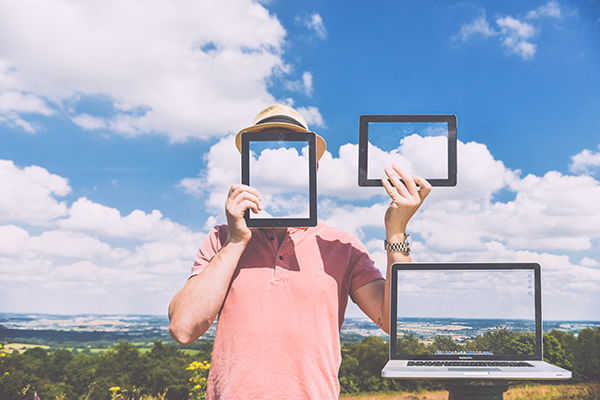 man posing with tablets and clouds