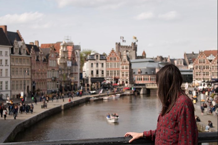 standing on bridge in european city