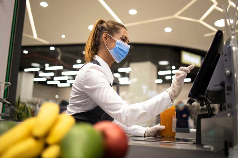 cashier wearing mask at grocery store check out